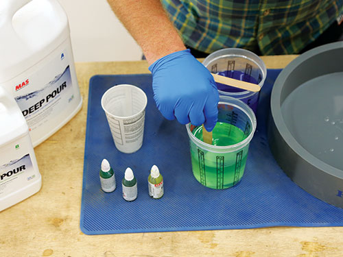 Stirring green dye into epoxy mix