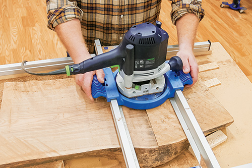 Running router over wood surface with flattening jig