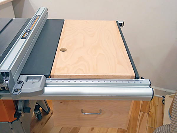 Storage unit built into table saw extension