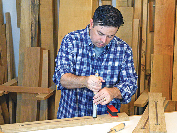 Willie Sandry chiseling an inlay in a woodworking project